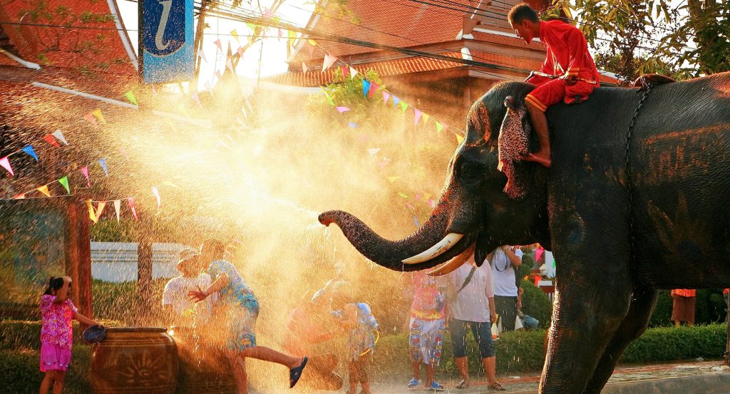 Children in traditional Thai costumes performing a cultural dance during a festival in Chiang Mai