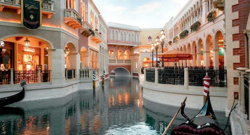 Indoor gondola gliding under bridges inside the Venetian Resort