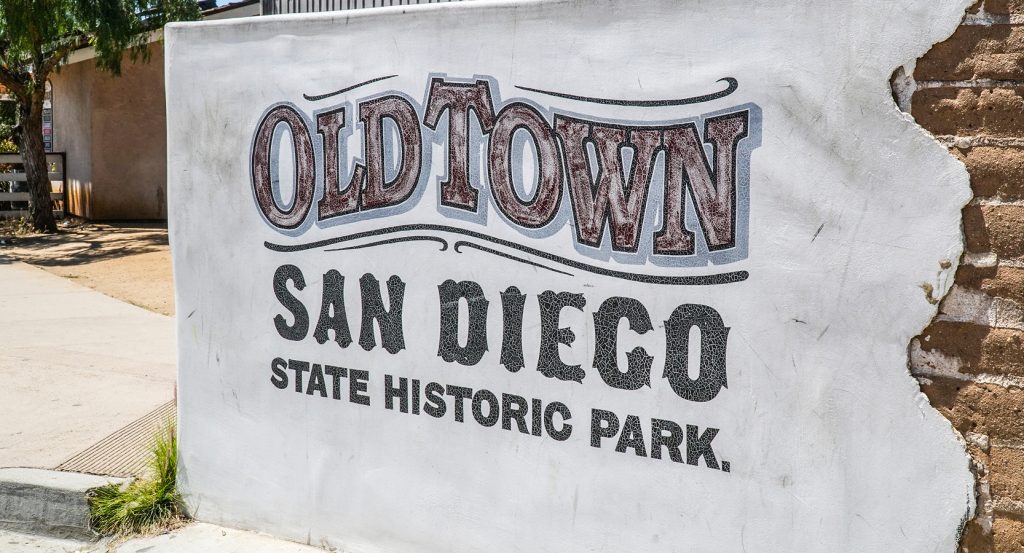 Historic adobe buildings and lively street in Old Town San Diego