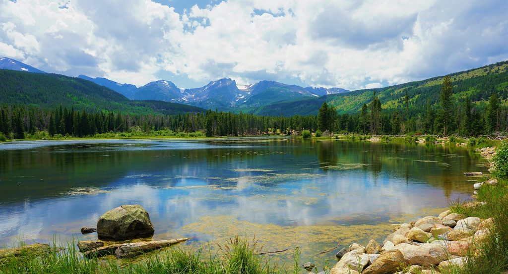 Sunrise over the peaks of Rocky Mountain National Park with golden light on the mountains