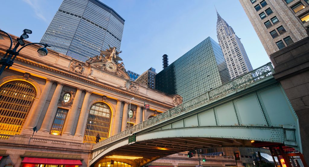 Interior of Grand Central Terminal with the four-faced brass clock and sunlit arched windows