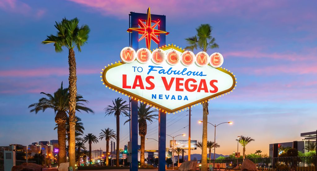 Iconic Las Vegas welcome sign glowing at sunset