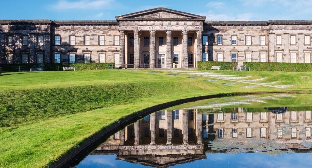 Neoclassical facade of the Scottish National Gallery in Edinburgh under blue sky