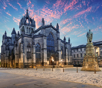 St Giles’ Cathedral on Edinburgh’s Royal Mile at sunset, with the statue of John Knox in the foreground.