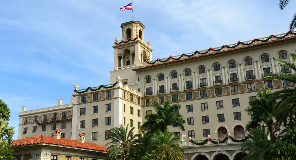 Arched entrance and palm-lined drive at The Breakers Palm Beach oceanfront resort
