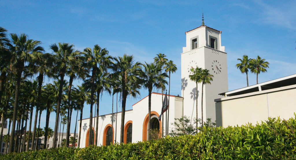 Exterior view of Union Station with palm trees against a blue sky
