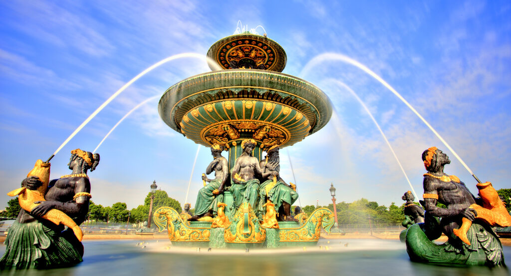 Bronze statues and water streams of Place de la Concorde Fountain