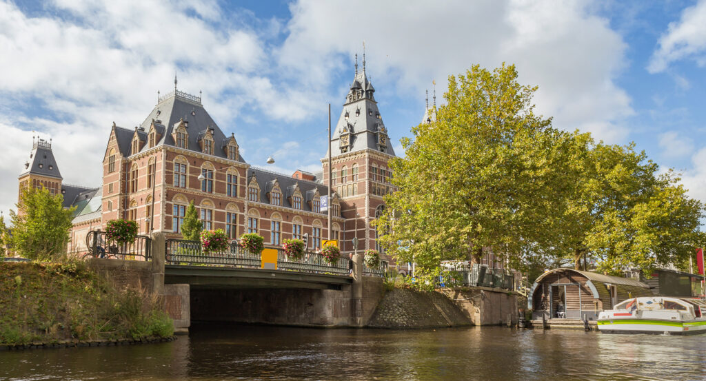 Front facade of Rijksmuseum under blue sky in Amsterdam