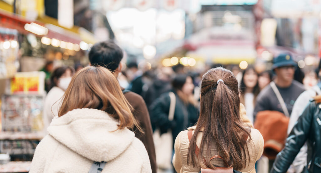 Busy scene at Ameyoko Market with people and lights near Ueno Station