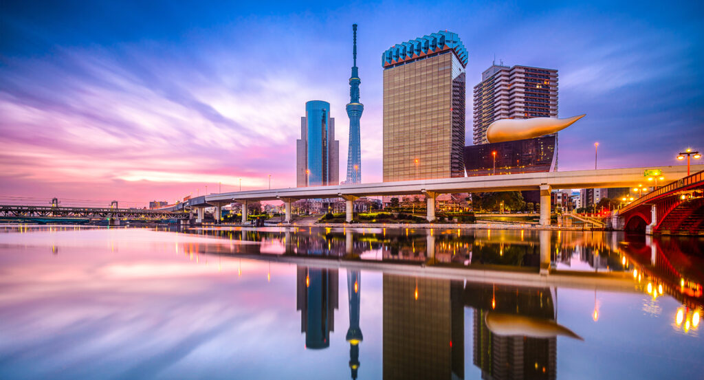 Evening reflections of the Sumida River in Tokyo with city lights and bridges