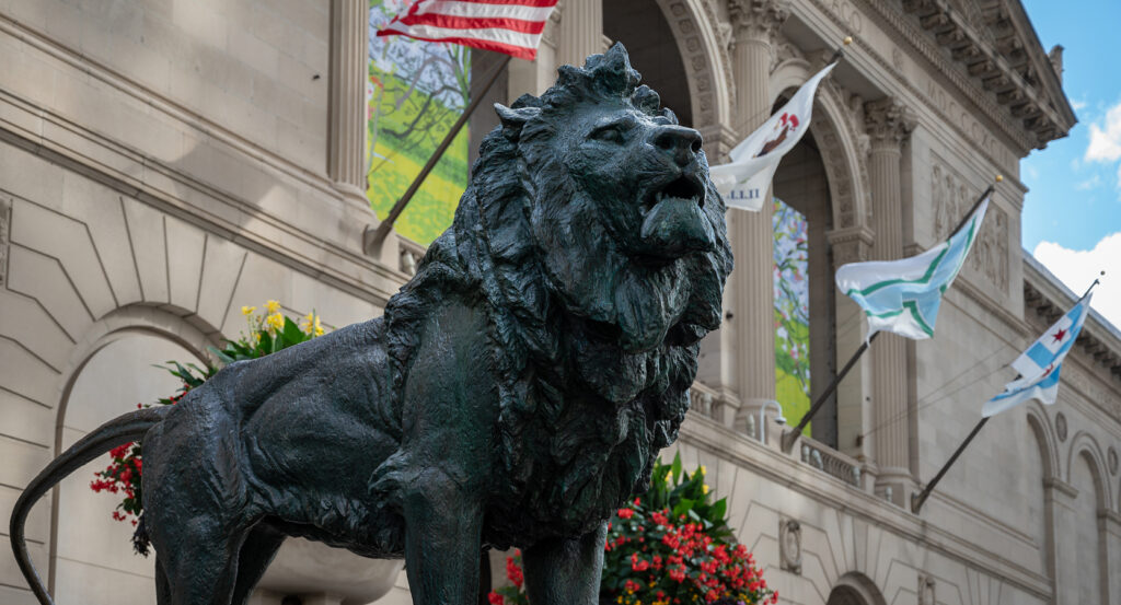 Front view of the Art Institute of Chicago with flags and flowers