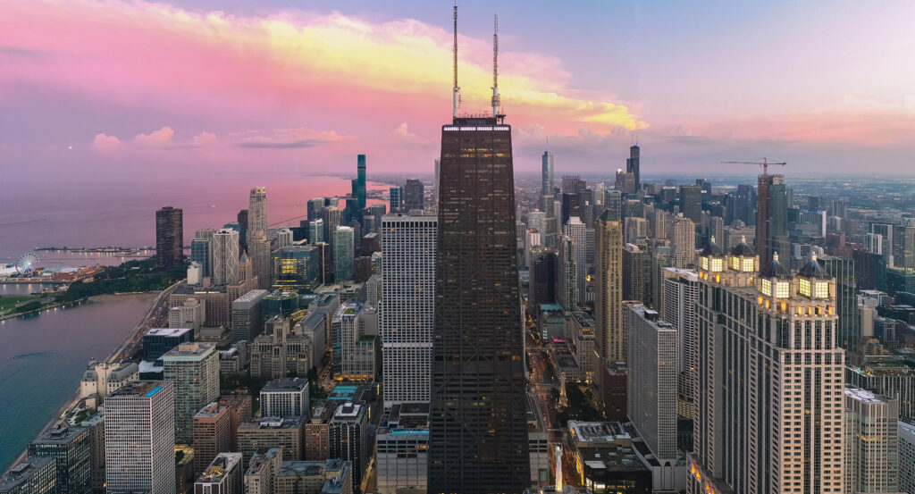 View from 360 Chicago observation deck overlooking the city and lake.