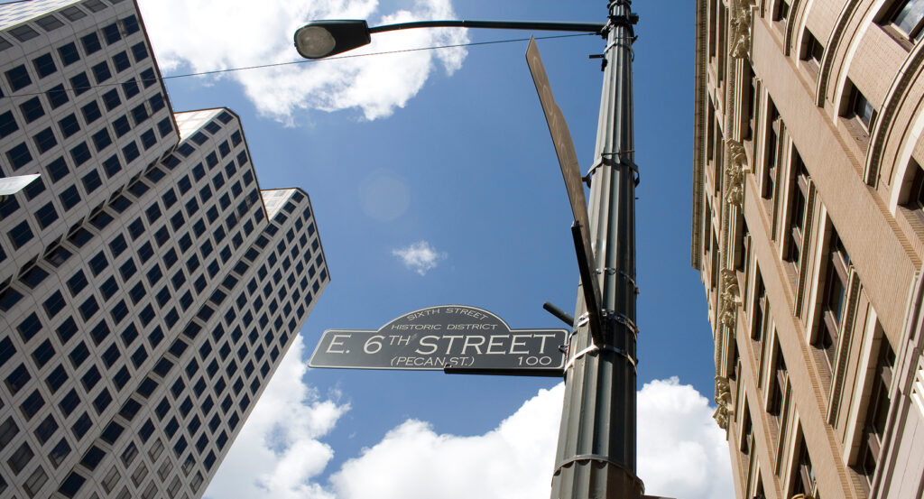 Historic 6th Street in Austin with lively bars, music venues, and neon lights at night