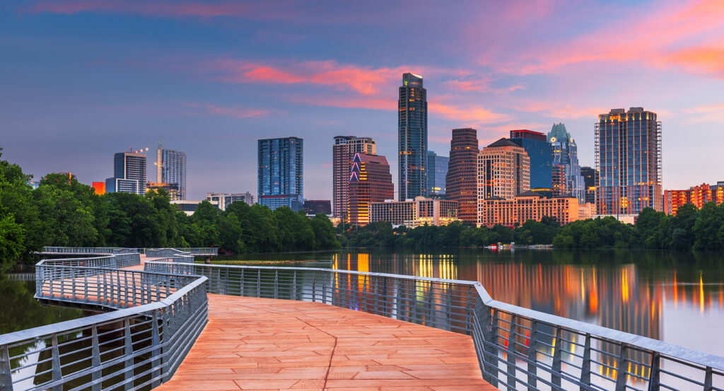 Iconic South Congress Avenue in Austin with shops, neon lights, and skyline backdrop