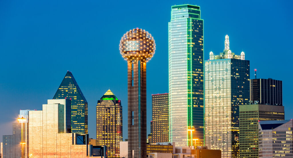 Night view of Reunion Tower illuminated above downtown Dallas
