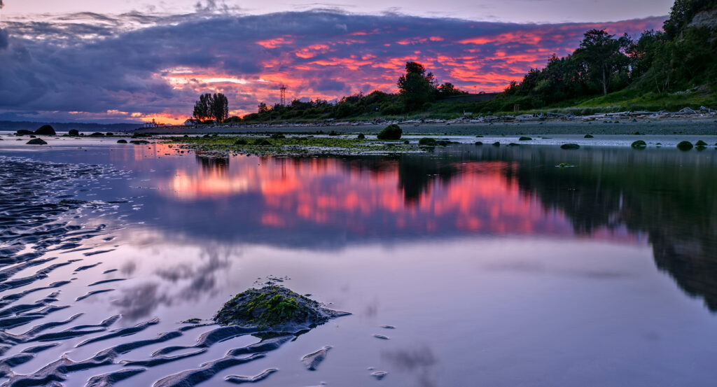 Discovery Park shoreline at dusk with vivid skies and tidal flats