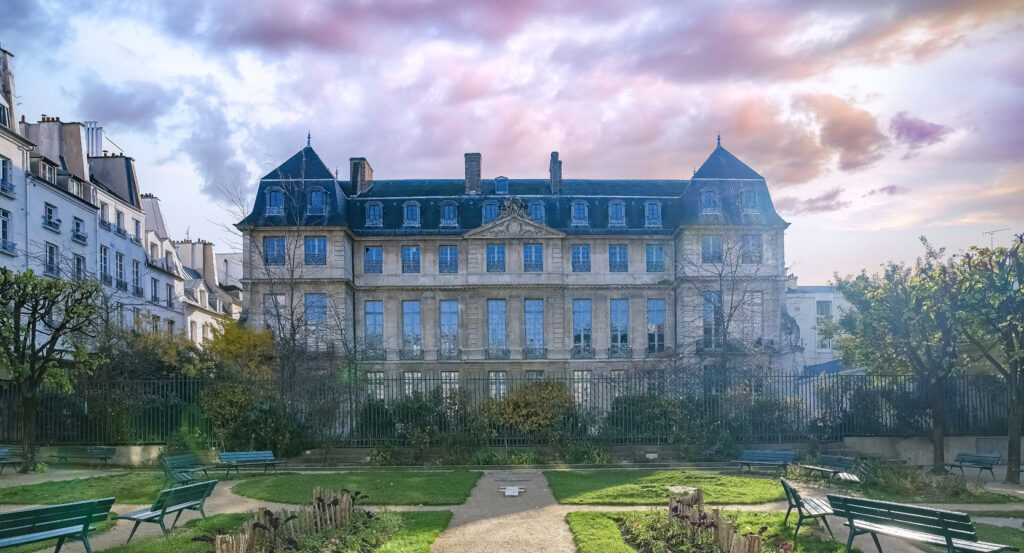 Stone facade of the Picasso Museum in Barcelona under colorful sky