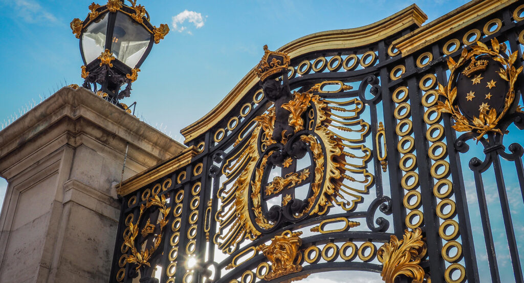 Close-up of Buckingham Palace entrance with intricate black and gold design