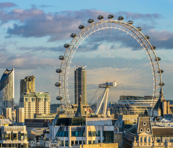 London Eye overlooking Westminster skyline in London at golden hour