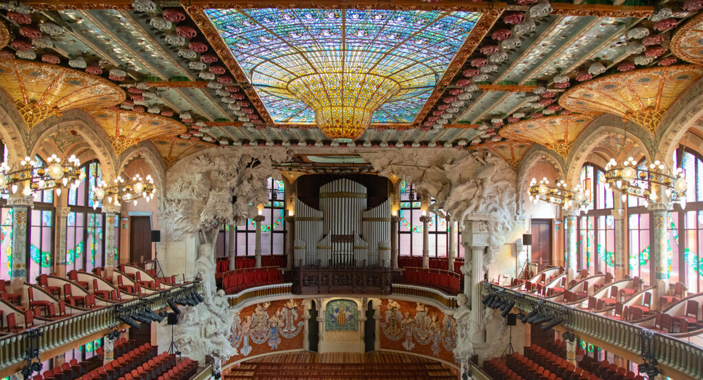 Concert hall of the Palau de la Musica Catalana featuring mosaic columns and decorative ceiling