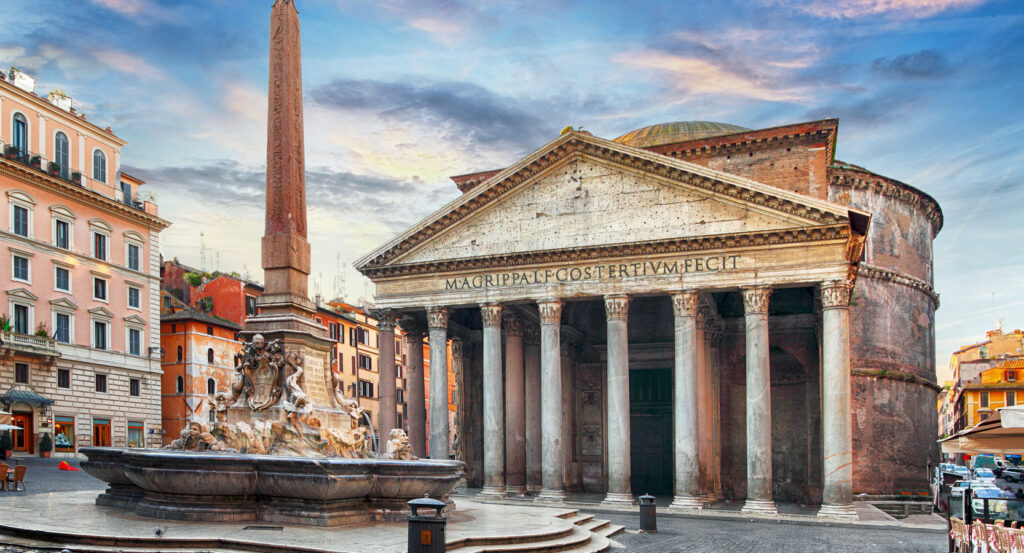 Exterior view of the Pantheon in Rome at sunrise with the obelisk fountain in the foreground