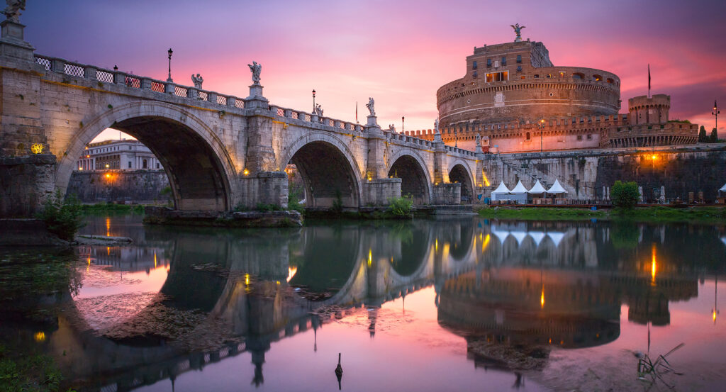 Ponte Sant’Angelo bridge leading to Castel Sant’Angelo in Rome at twilight