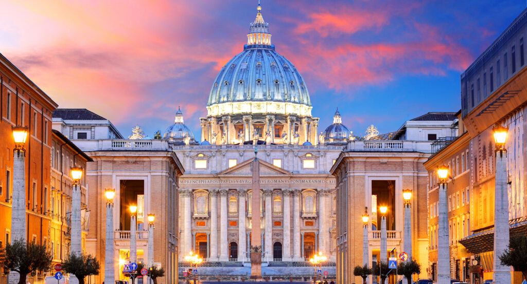 Vatican City skyline with St. Peter’s dome illuminated at dusk