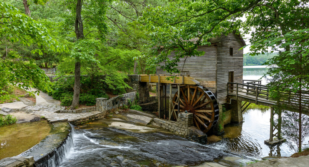 Scenic nature view at Stone Mountain Park with trees, stream, and historic mill