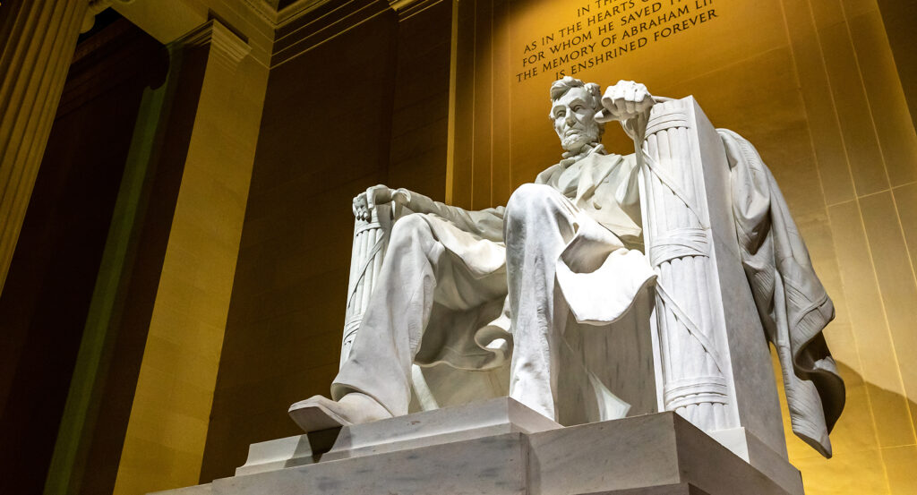 Marble statue of Abraham Lincoln seated at the Lincoln Memorial in Washington DC