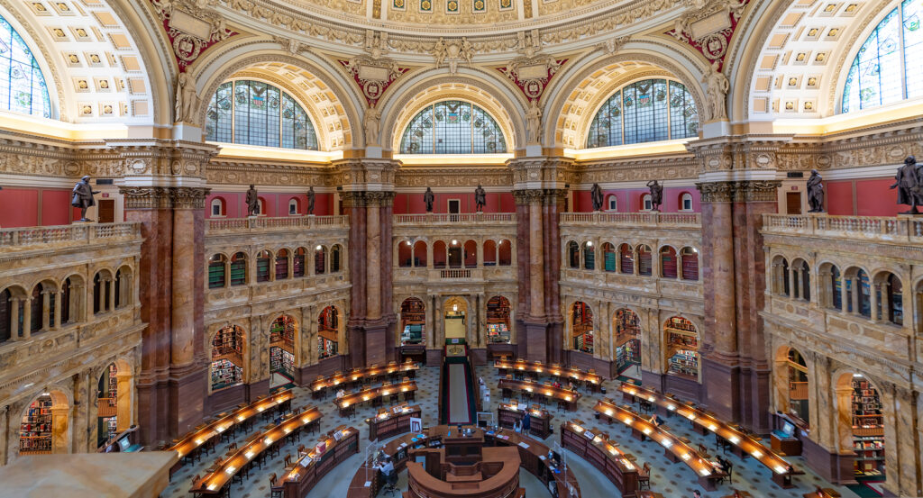 Grand dome ceiling of the Library of Congress in Washington DC with classical arches and windows