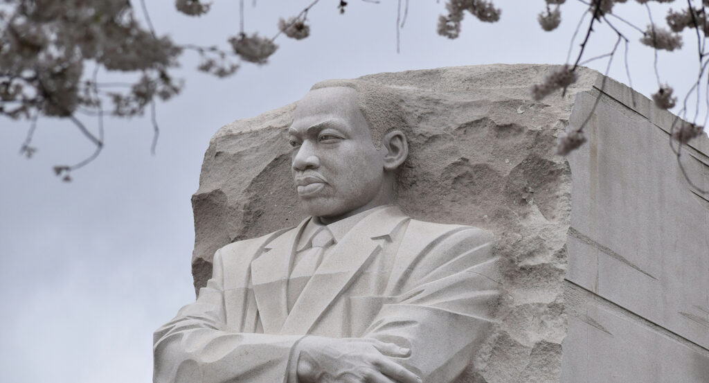 Stone of Hope monument at the Martin Luther King Jr Memorial framed by cherry blossoms
