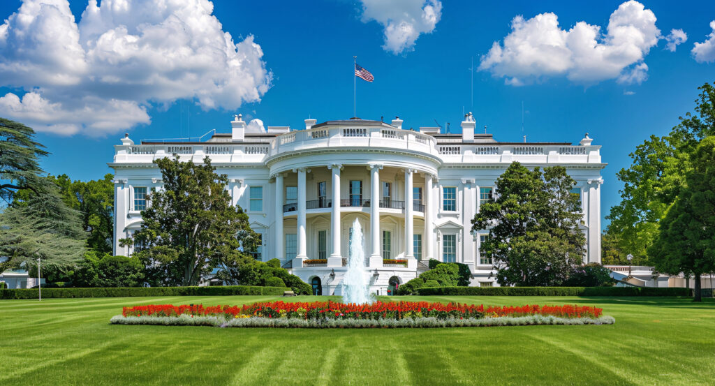 Front view of the White House on a sunny day with green lawn
