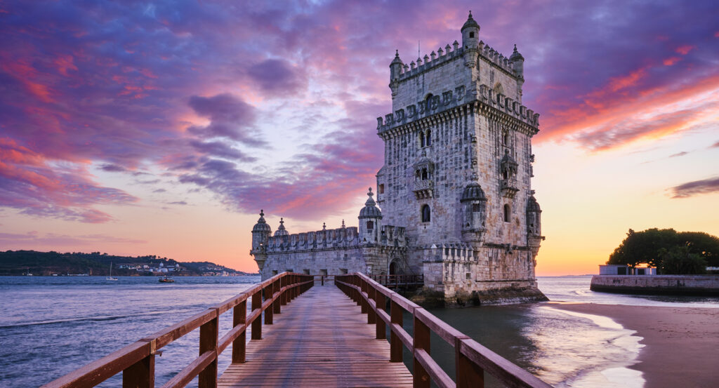 Historic Belem Tower on the Lisbon waterfront with colorful sky