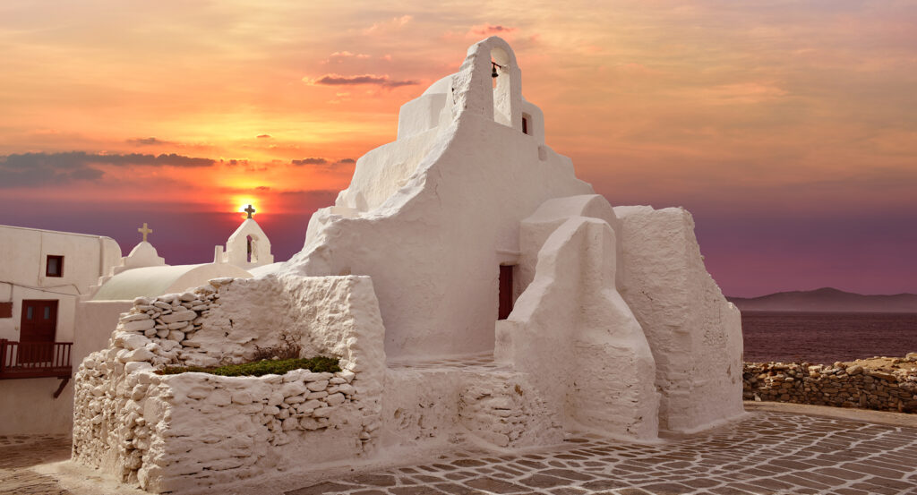 Iconic layered architecture of Paraportiani Church in Mykonos at twilight.