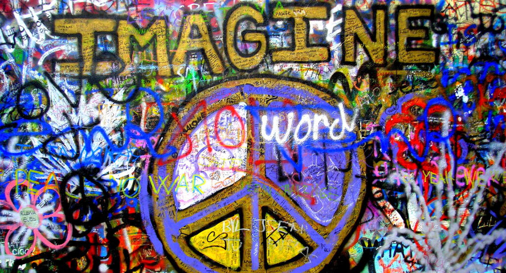 Lennon Wall in Prague covered with vibrant street art and messages of peace
