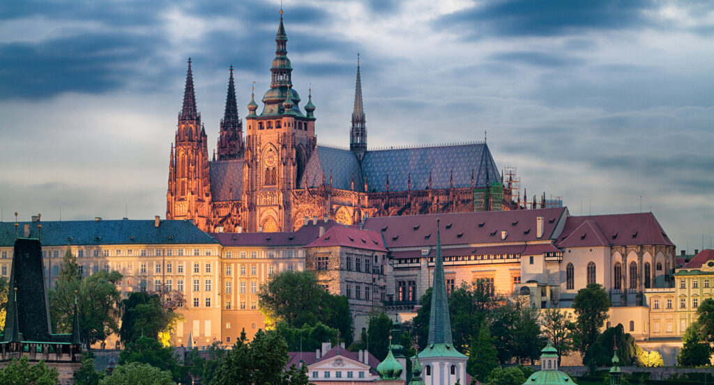 Panoramic view of Prague Castle rising over rooftops
