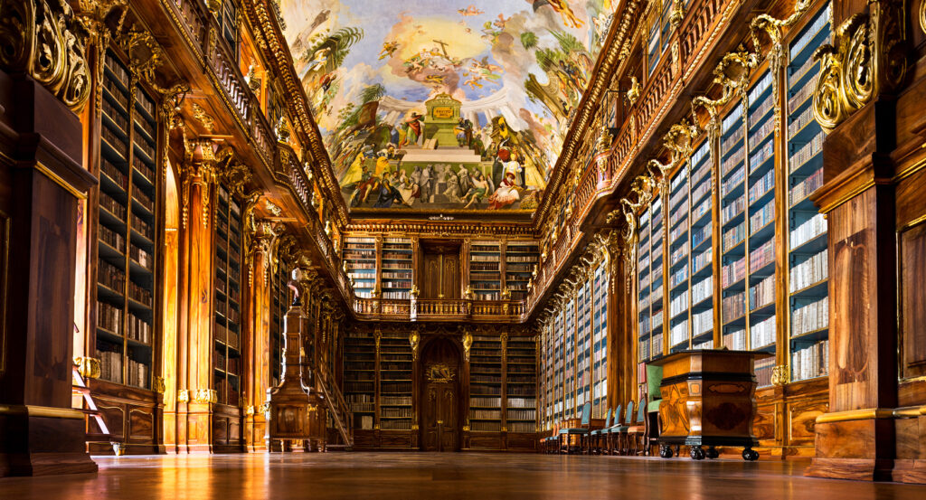 Strahov Library in Prague featuring historic books, frescoed ceilings, and baroque woodwork