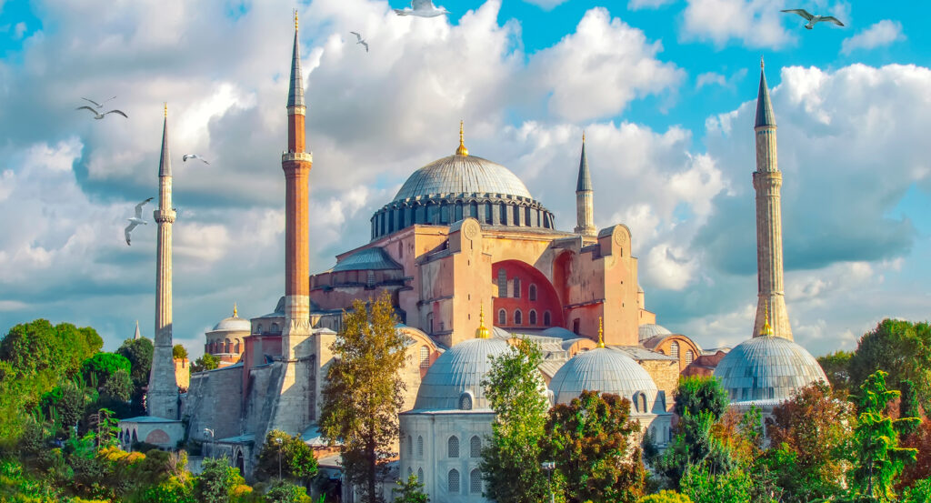 Hagia Sophia landmark in Istanbul surrounded by greenery and dramatic clouds