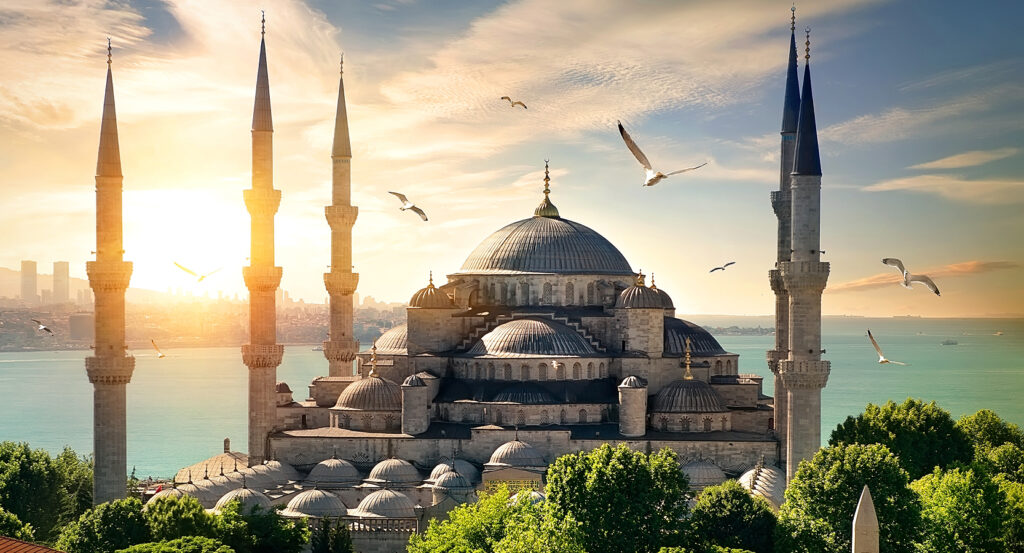 Exterior view of Sultan Ahmed Mosque, known as the Blue Mosque, with minarets and domes against the Bosphorus