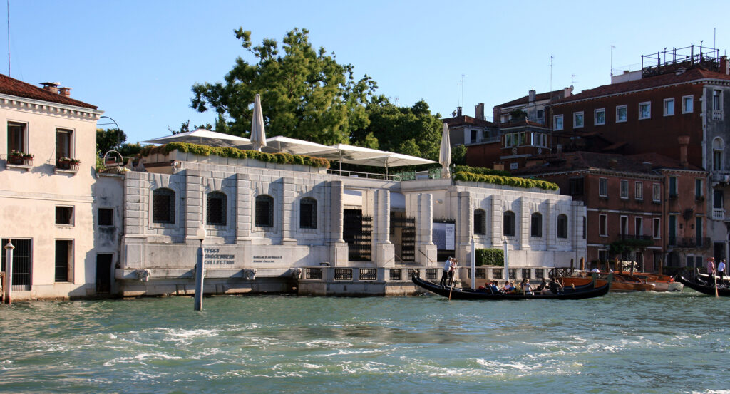 Peggy Guggenheim Museum building on the Grand Canal with gondolas nearby