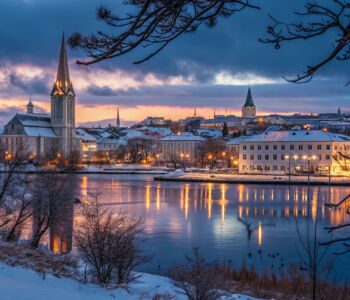Reykjavik skyline reflected in Lake Tjörnin at dusk