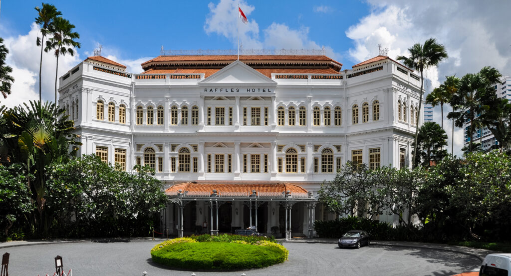 Iconic Raffles Hotel in Singapore with historic architecture and lush greenery