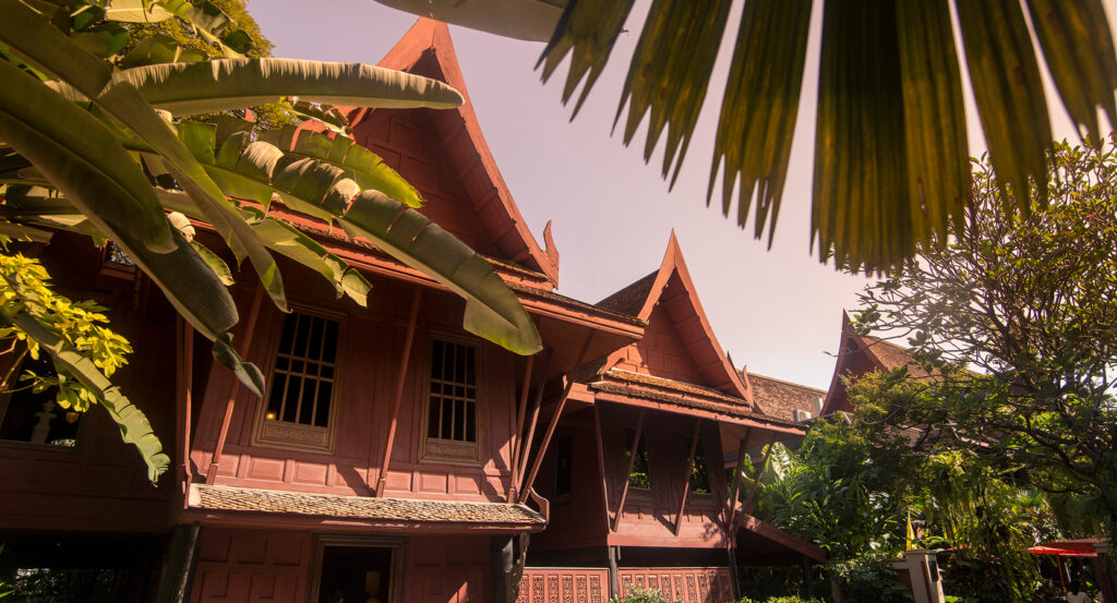 Gardens and red houses at Jim Thompson House Bangkok
