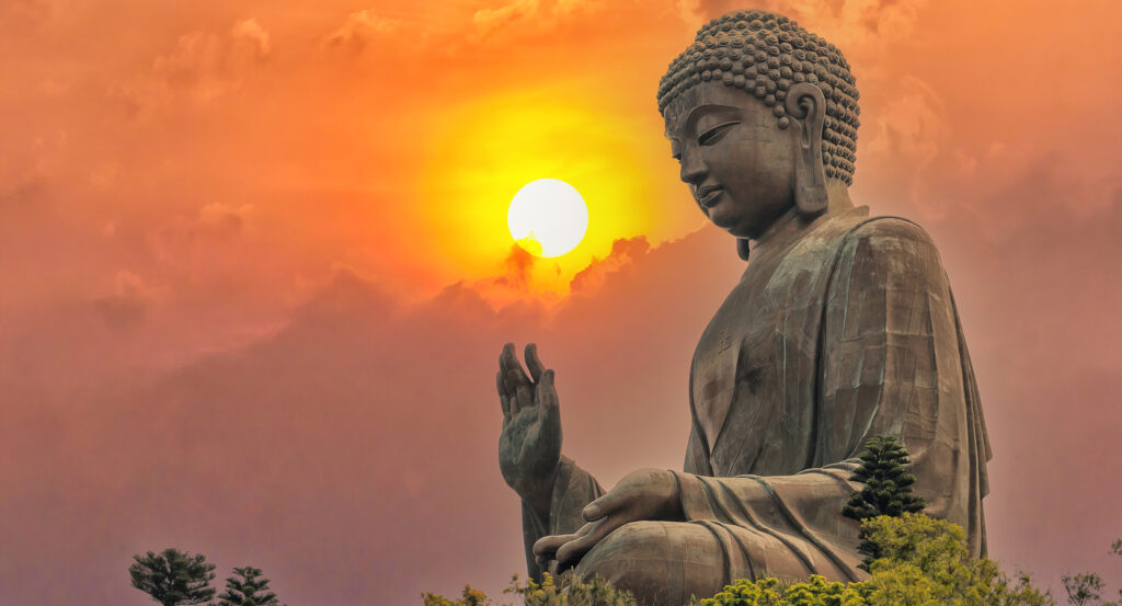 View of the Big Buddha with the sun setting behind on Lantau Island, Hong Kong