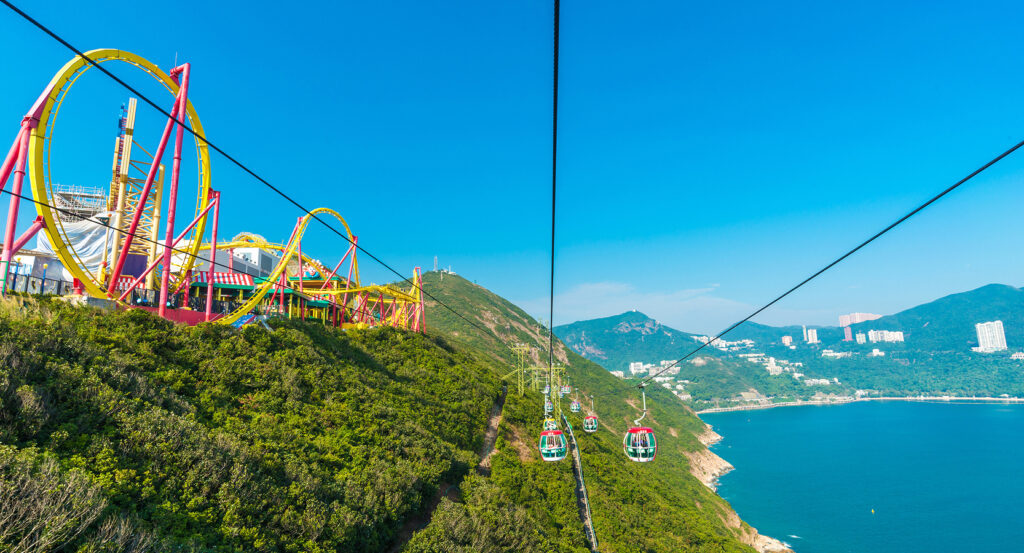 Colorful roller coaster at Ocean Park overlooking the coastline