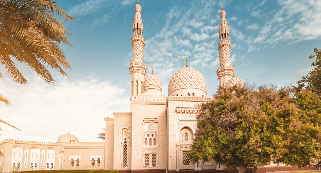 Exterior of Jumeirah Mosque glowing in warm afternoon light