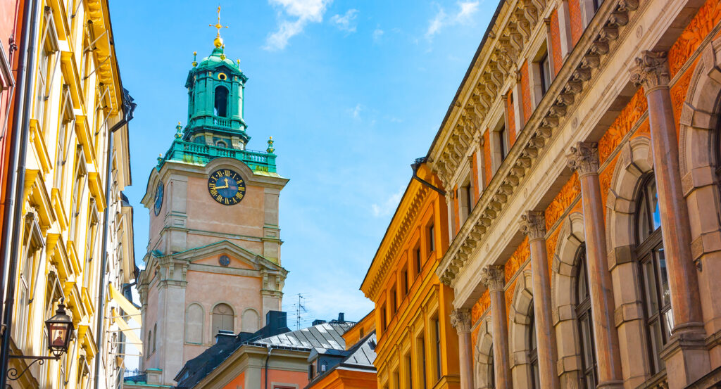 View of Storkyrkan Cathedral tower rising over old town streets in Stockholm