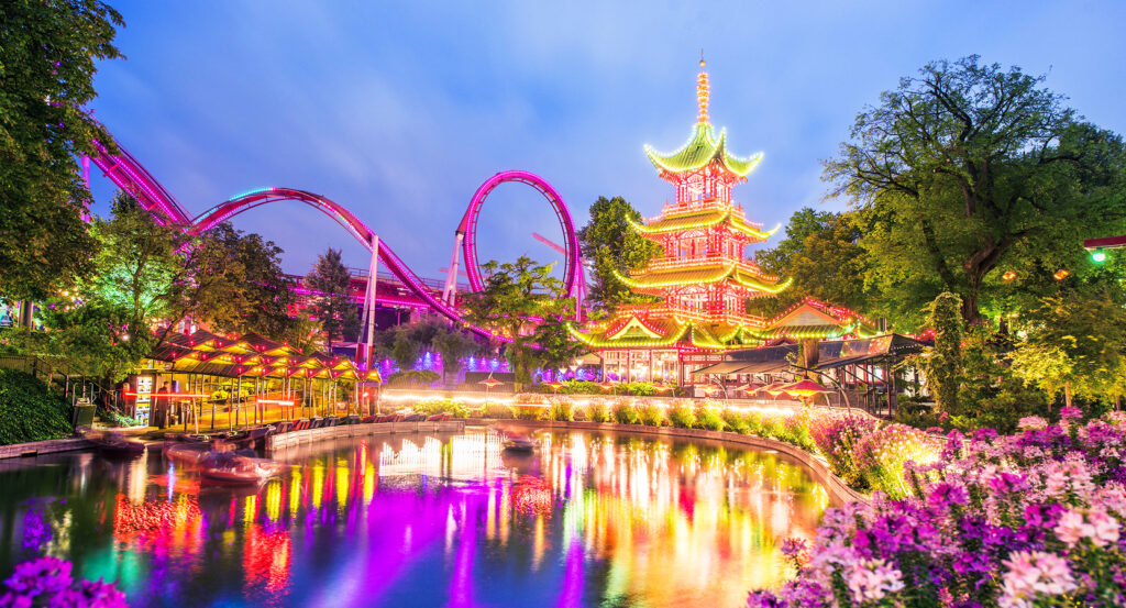 Colorful lights reflecting over the water at Tivoli Gardens