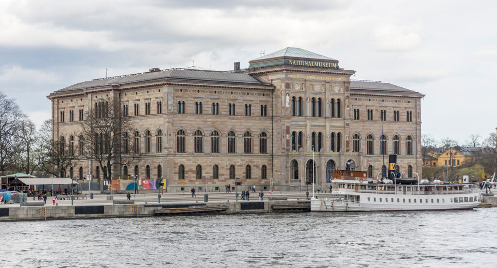 Copenhagen National Museum with riverfront view and moored boat
