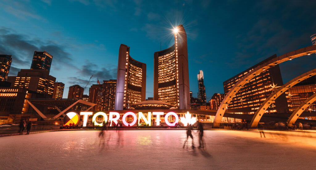 Skaters at Nathan Phillips Square in Toronto at dusk
